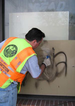 Streets and Sanitation Worker Wipes Away Graffiti