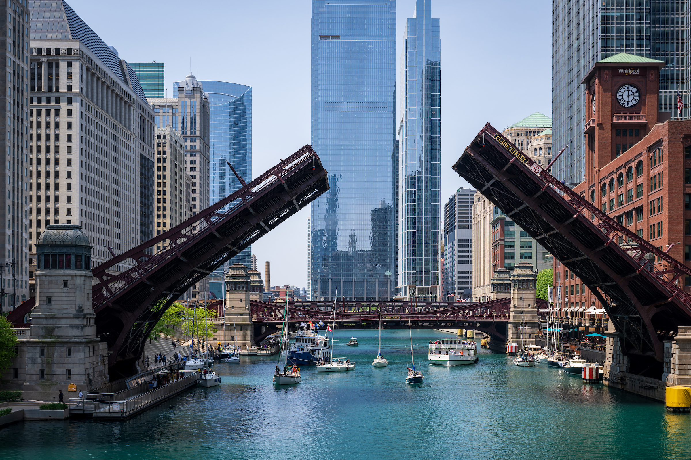 Bridges being lifted over the Chicago River to allow sailboats to pass underneath 