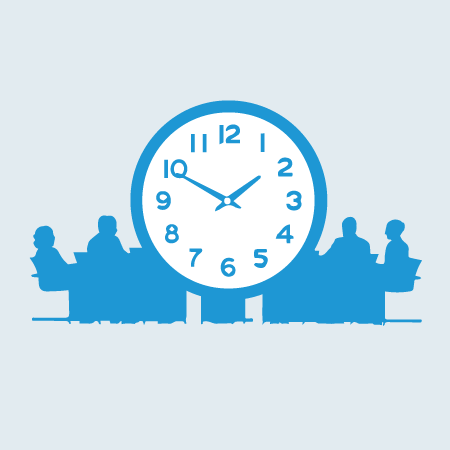 people at a meeting table and large clock
