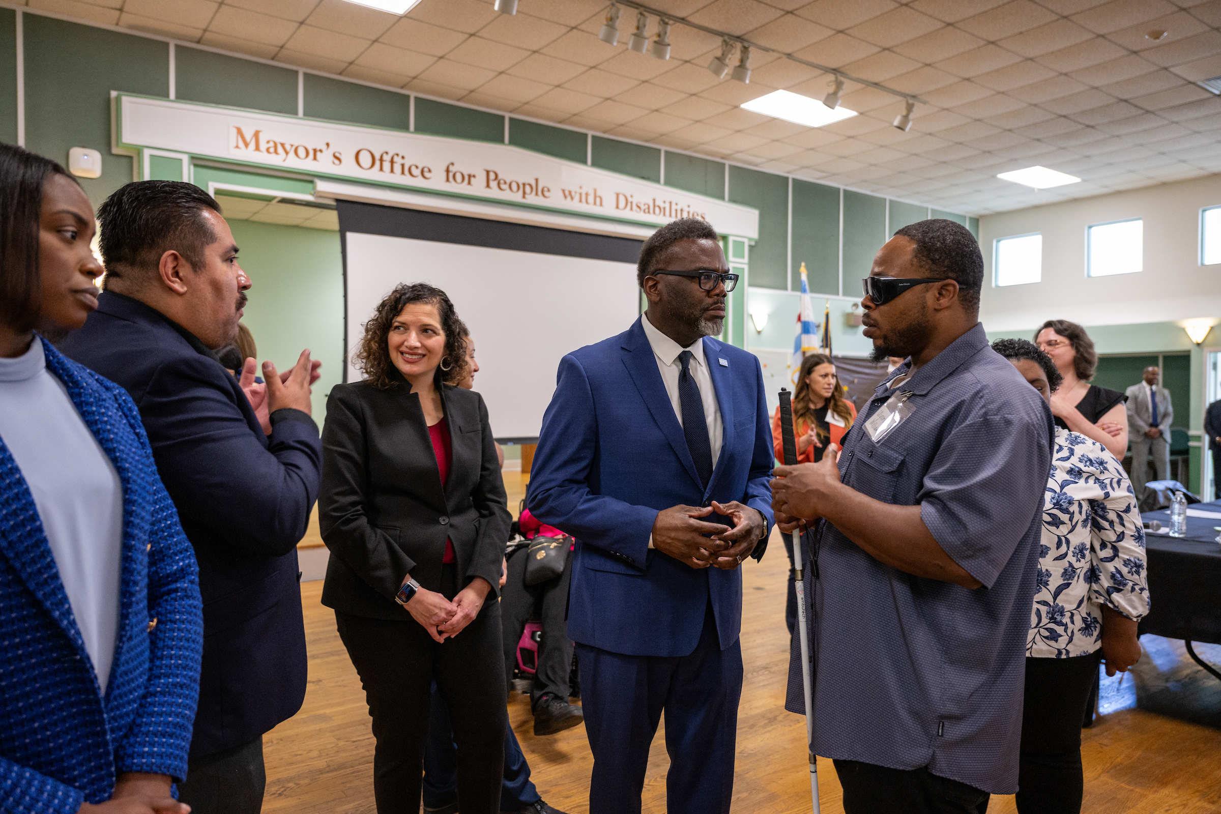 Mayor Brandon Johnson (center, in a blue suit with a beard) meets with MOPD Commissioner Rachel Arfa and constituents at the 2023 National Disability Employment Awareness Month Roundtable. 