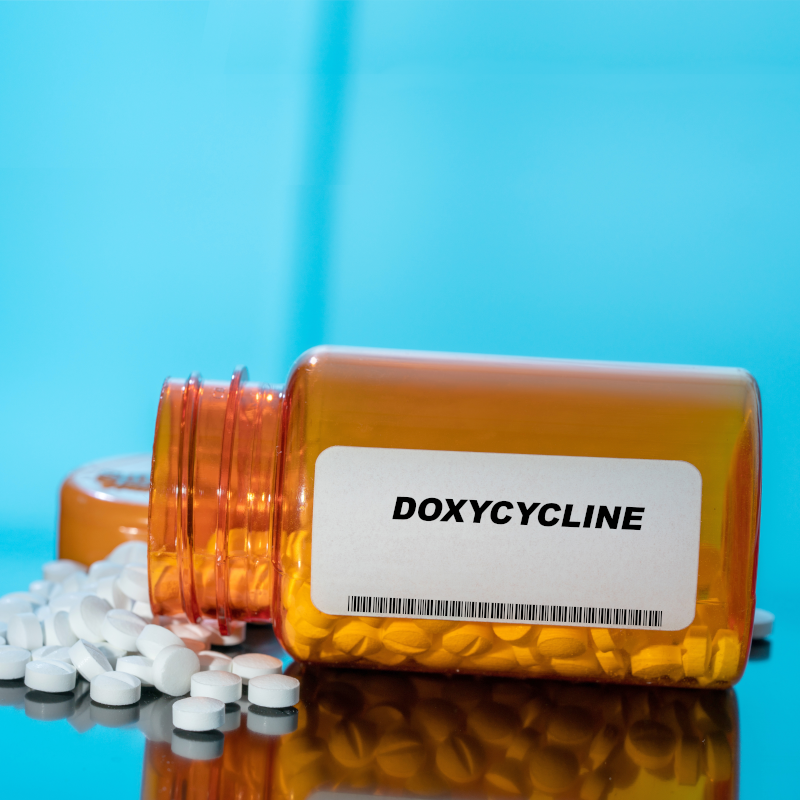 doxycycline prescription bottle with pills spilling out