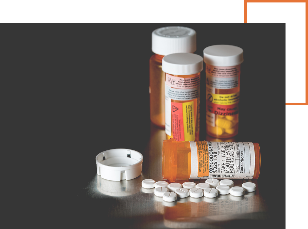 prescription pill bottles with several white pills scattered around them