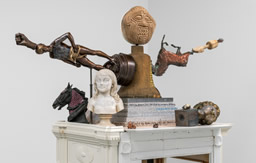 (Credit: American Golem; 2022; Found antiques, paper mache sculpture, granite, wood, metal base; Image courtesy of artist & Rhona Hoffman Gallery)